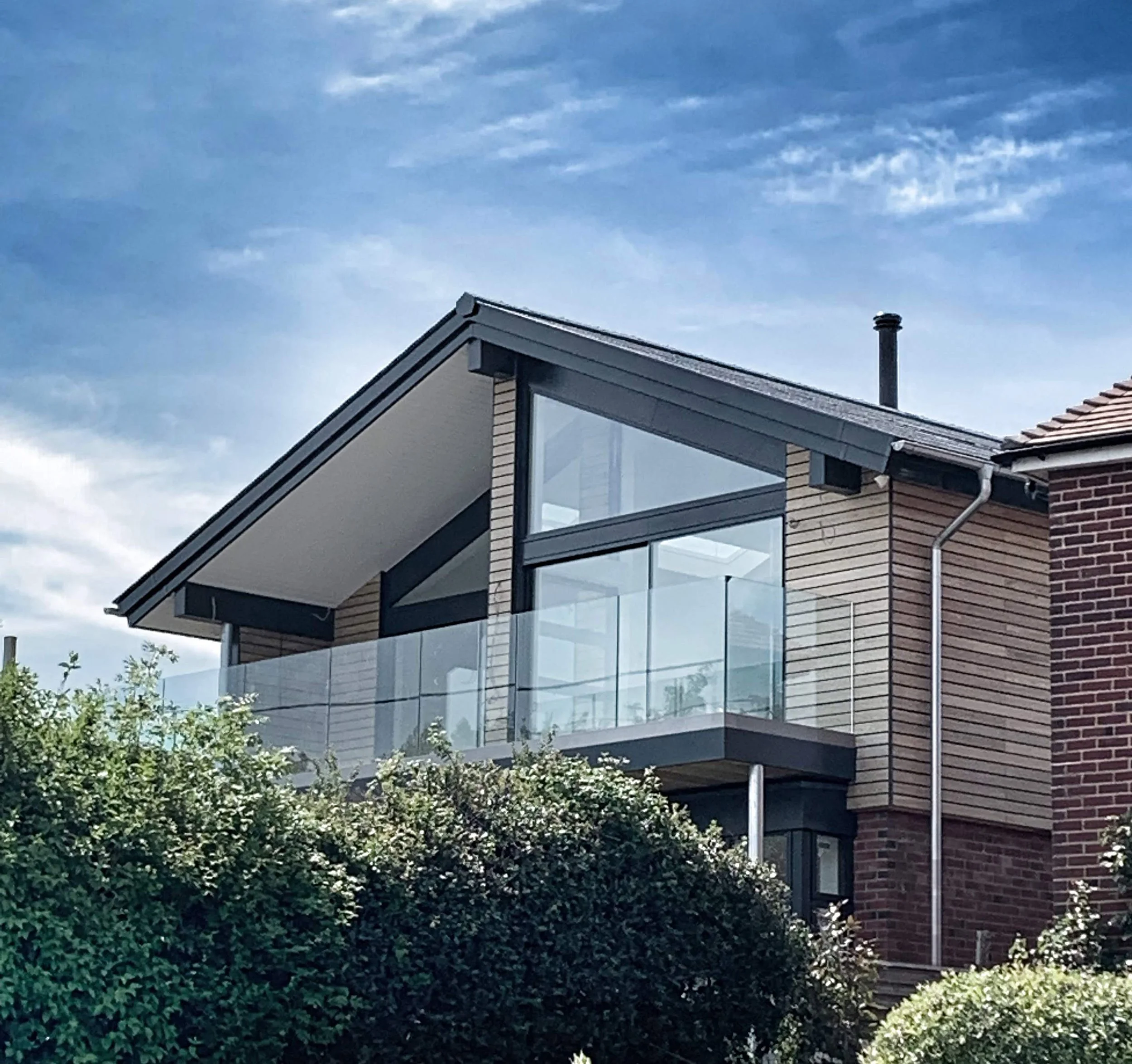 Completed bungalow remodel featuring an upside-down living arrangement with a front-facing balcony overlooking the river, designed by Tony Holt Design, a CIAT-registered architectural practice.