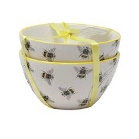 A set of  white bowls with a bee pattern, tied with yellow ribbon.
