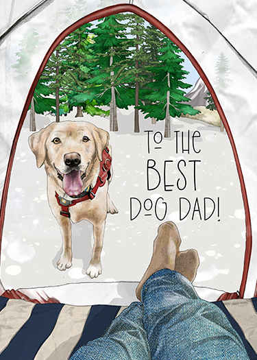 Person lying inside a tent looking out at a happy yellow Labrador Retriever dog standing outside the tent. The dog wears a red collar. The scene is outdoors in a wooded area with trees. Text on the tent reads 'To the best dog dad'.