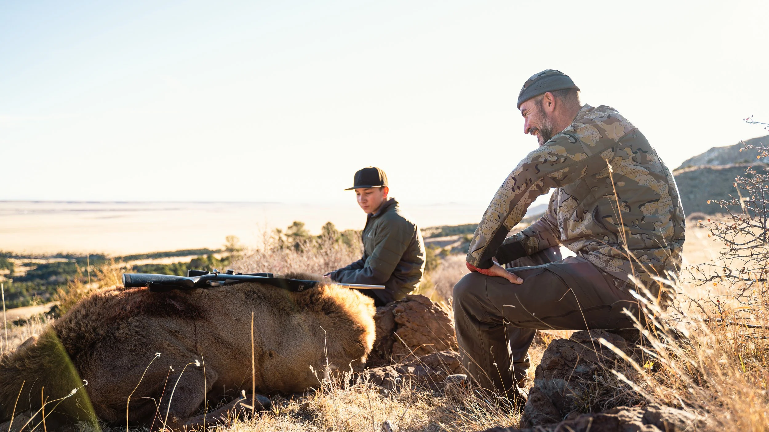 Two hunters with a bull elk in New Mexico
