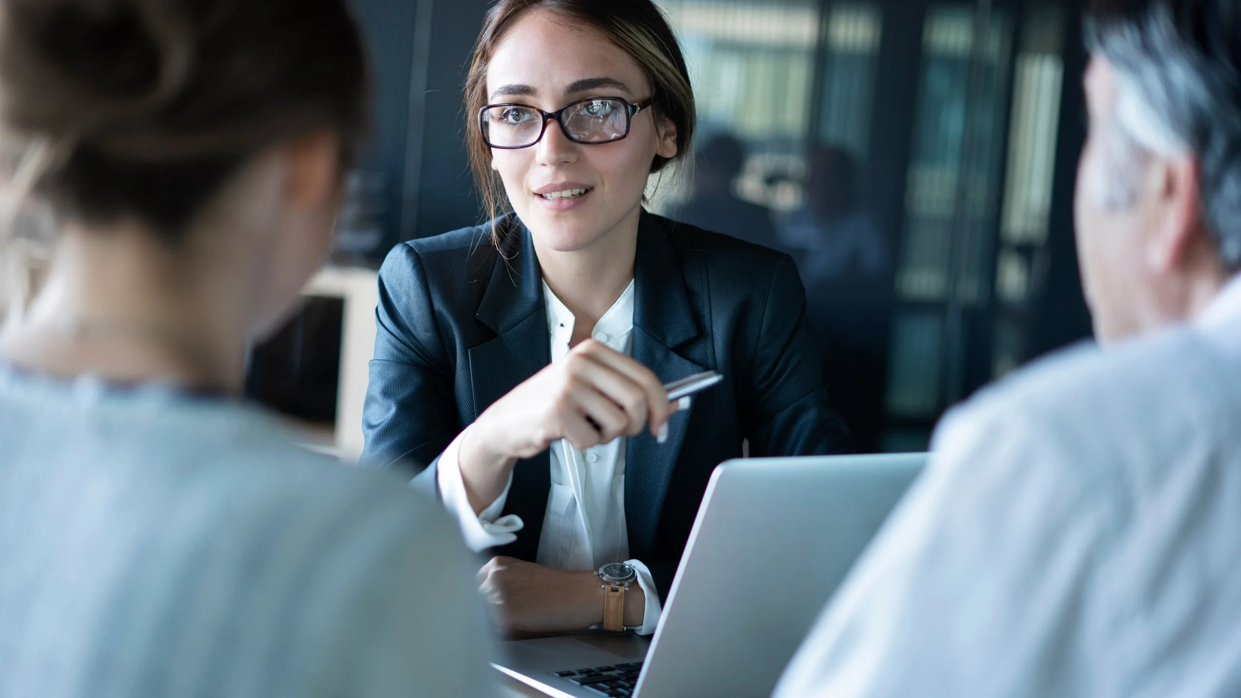 Lawyer talking with two clients in a law office.