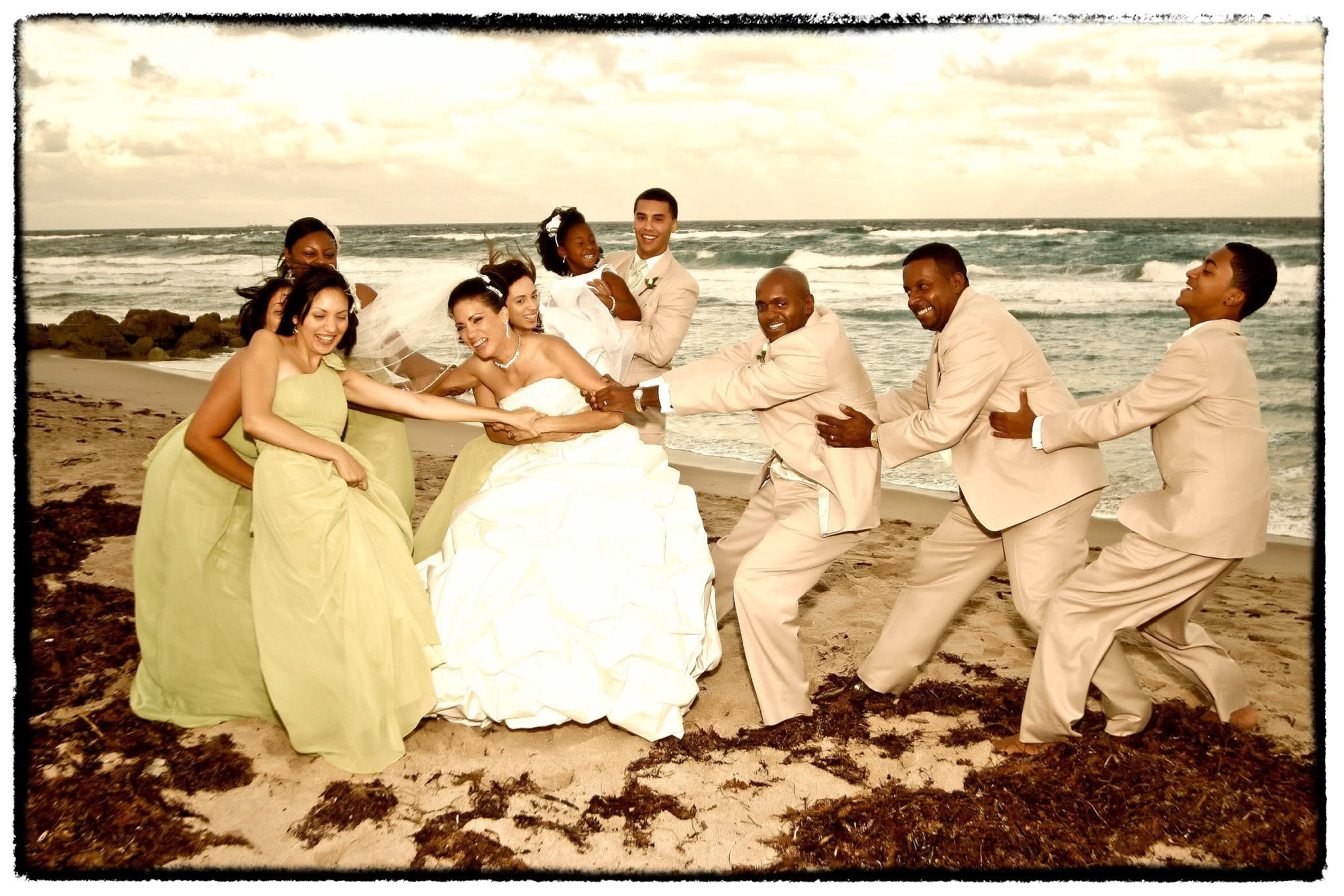 Wedding couple and wedding party celebrating on a Northeast Florida beach