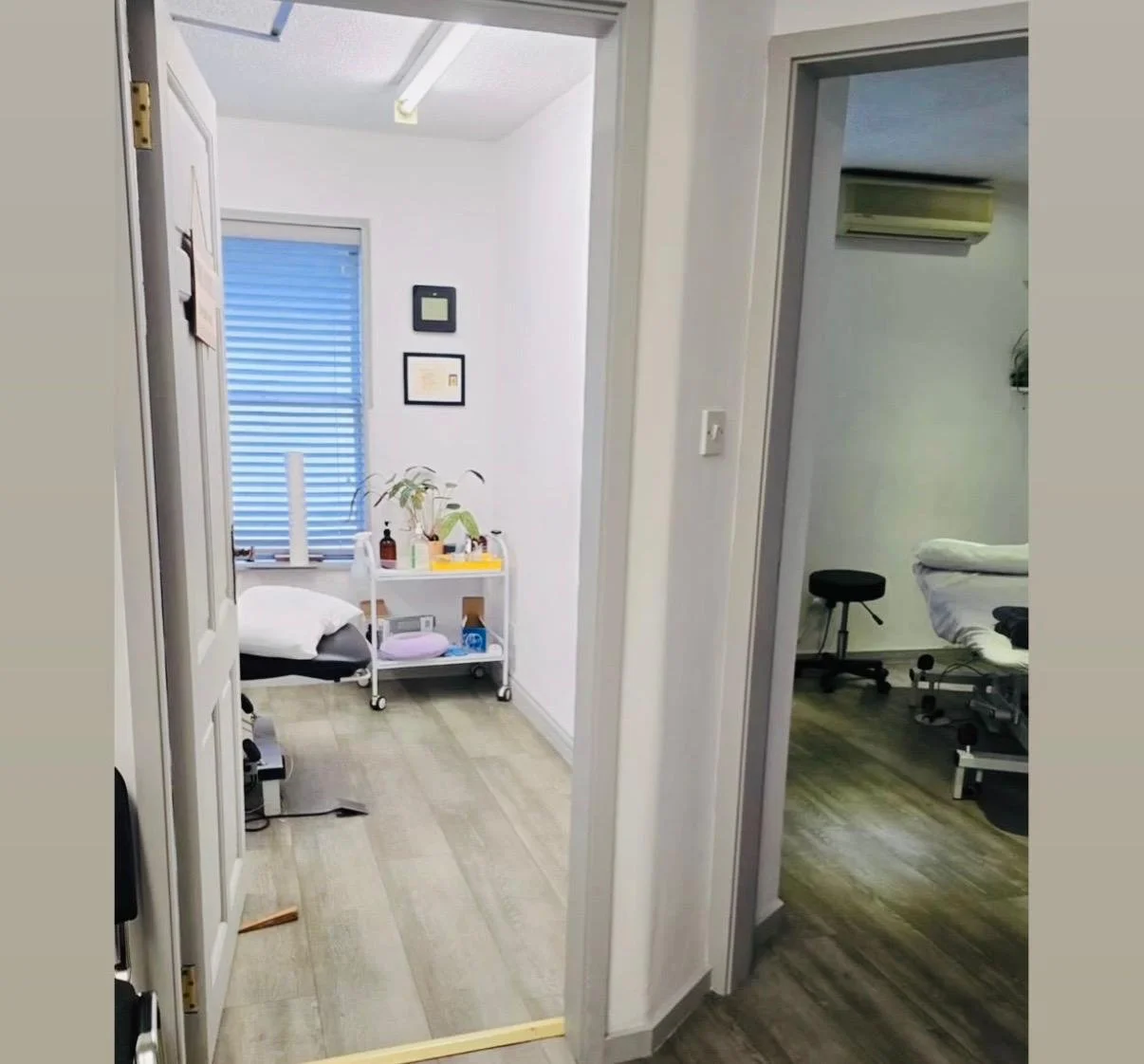 Hospital or clinic room with a bed, medical equipment, and a small rolling cart with supplies.