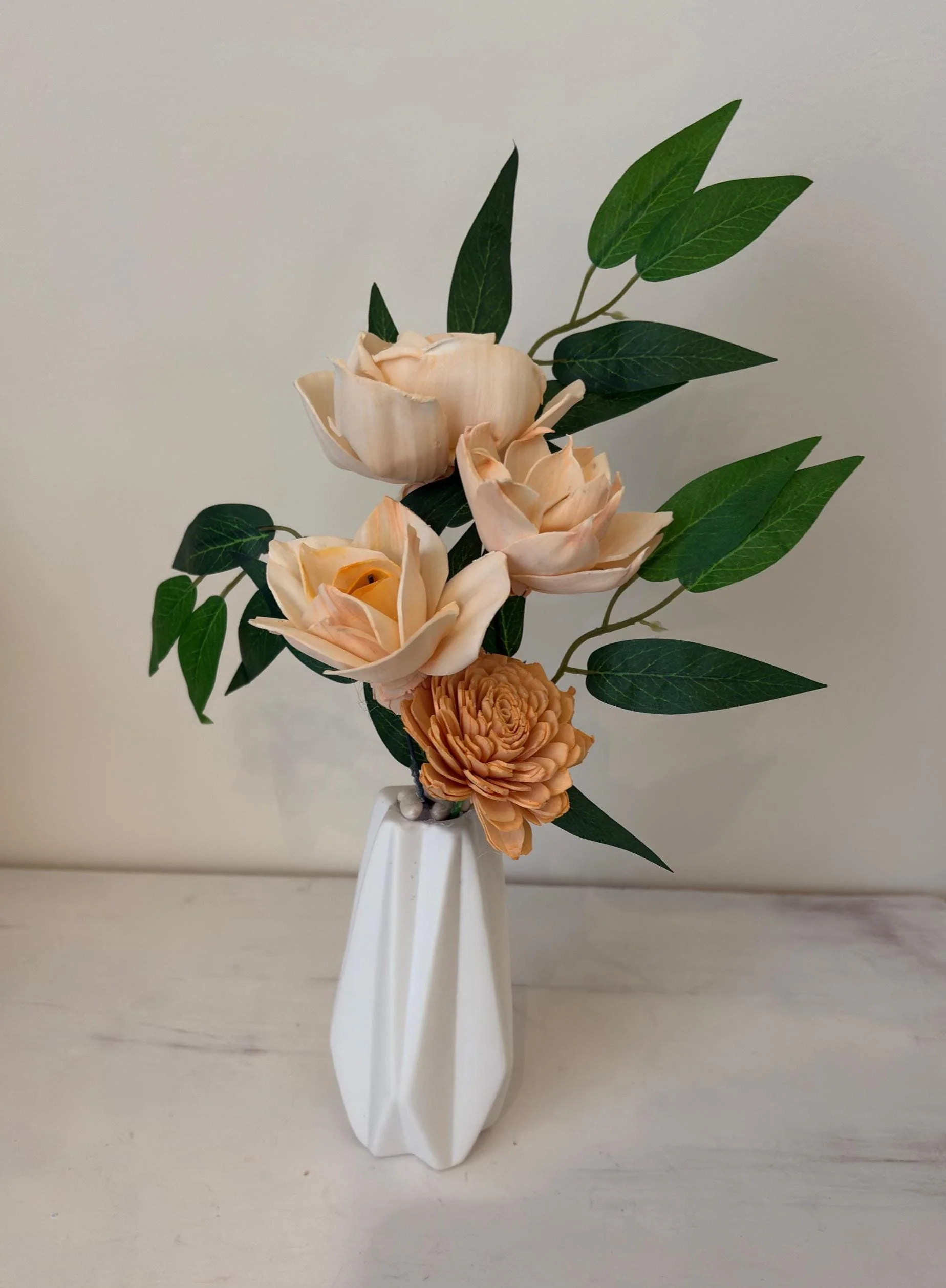 Hand-painted peach sola wood flowers in a white geometric bud vase
