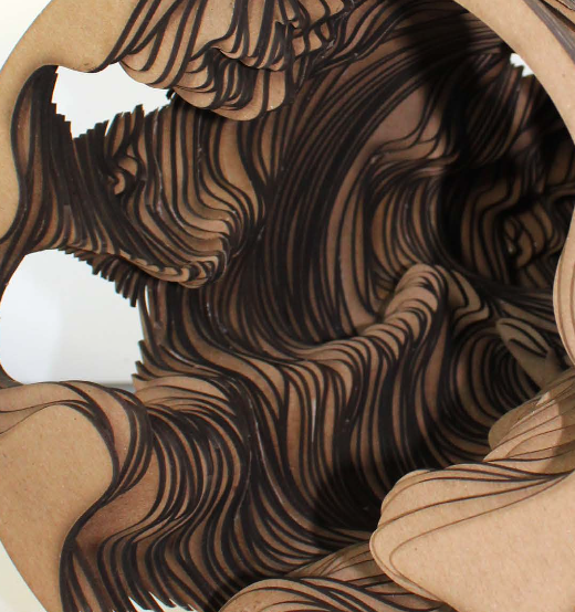 Close-up of layered, scalloped paper with black lines creating a textured pattern.