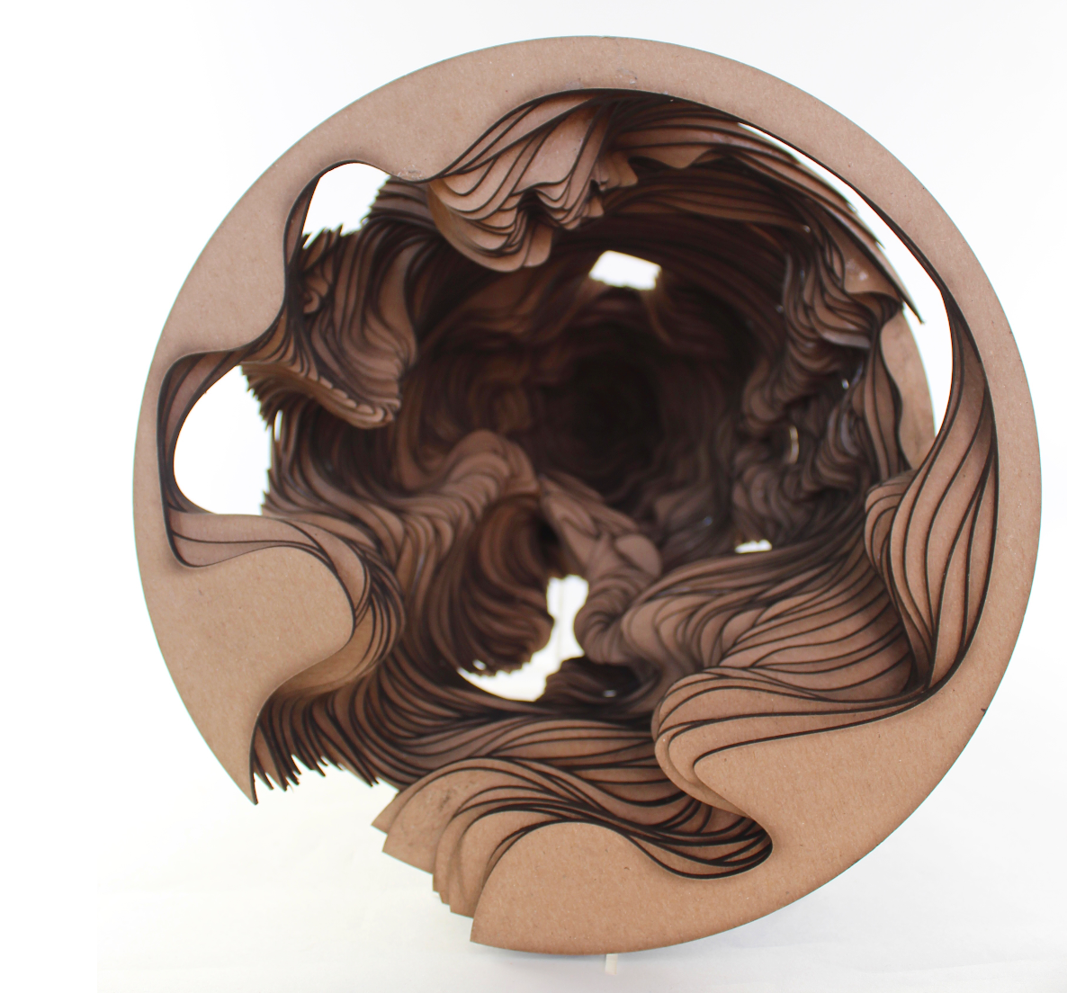 Top view of a cardboard tube with intricate black and brown paper curls inside.