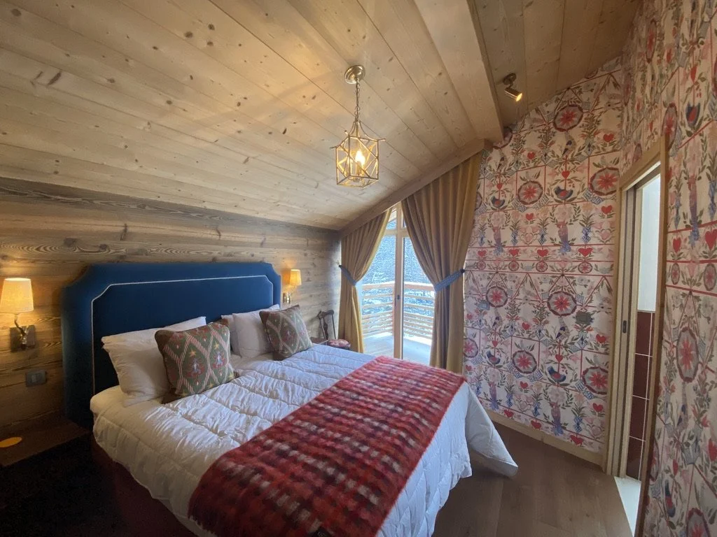 Bespoke velvet headboard co-ordinated with original wallpaper, cushions and made to measure curtains