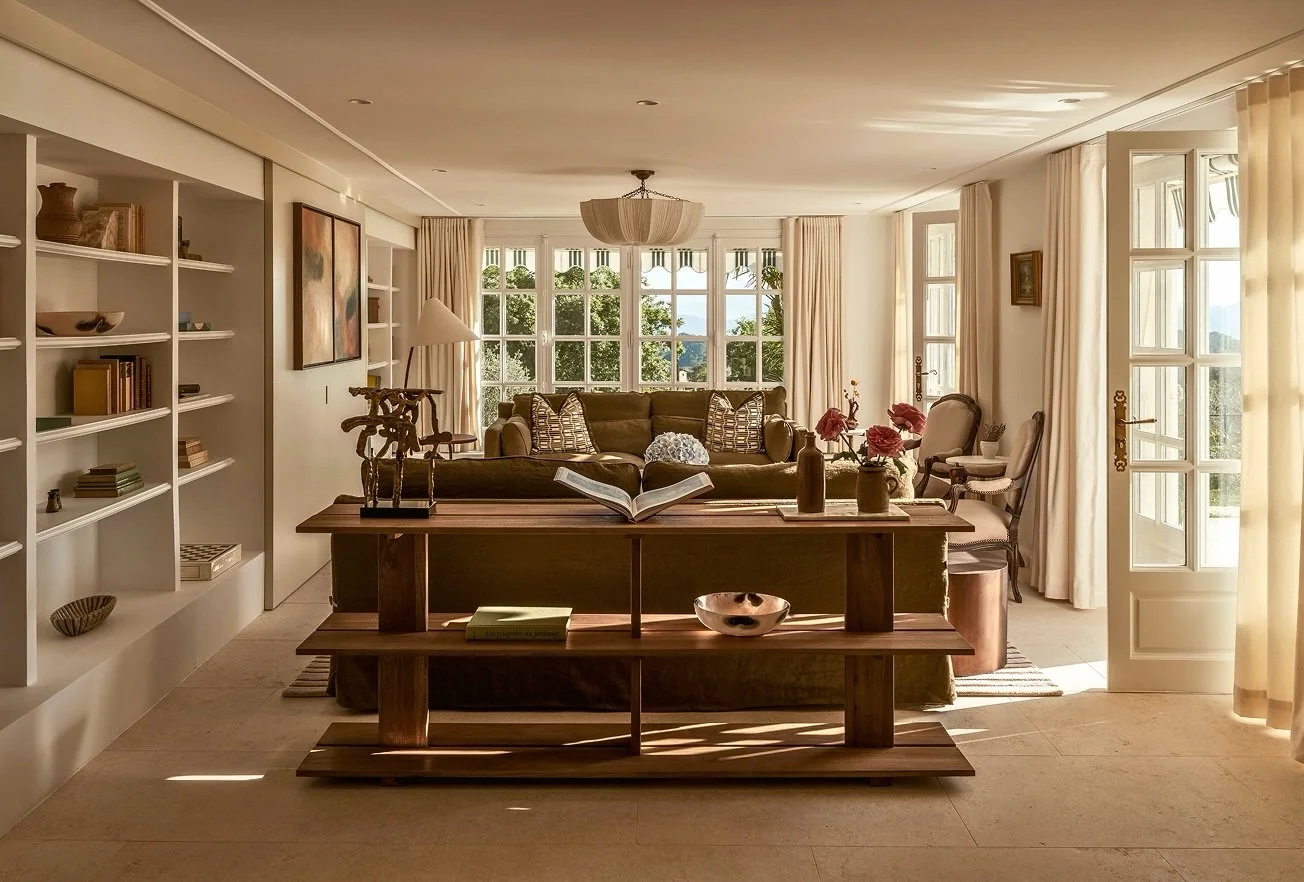 Made to measure curtains in a cream linen provide a subtle layer to a beautifully designed room.
