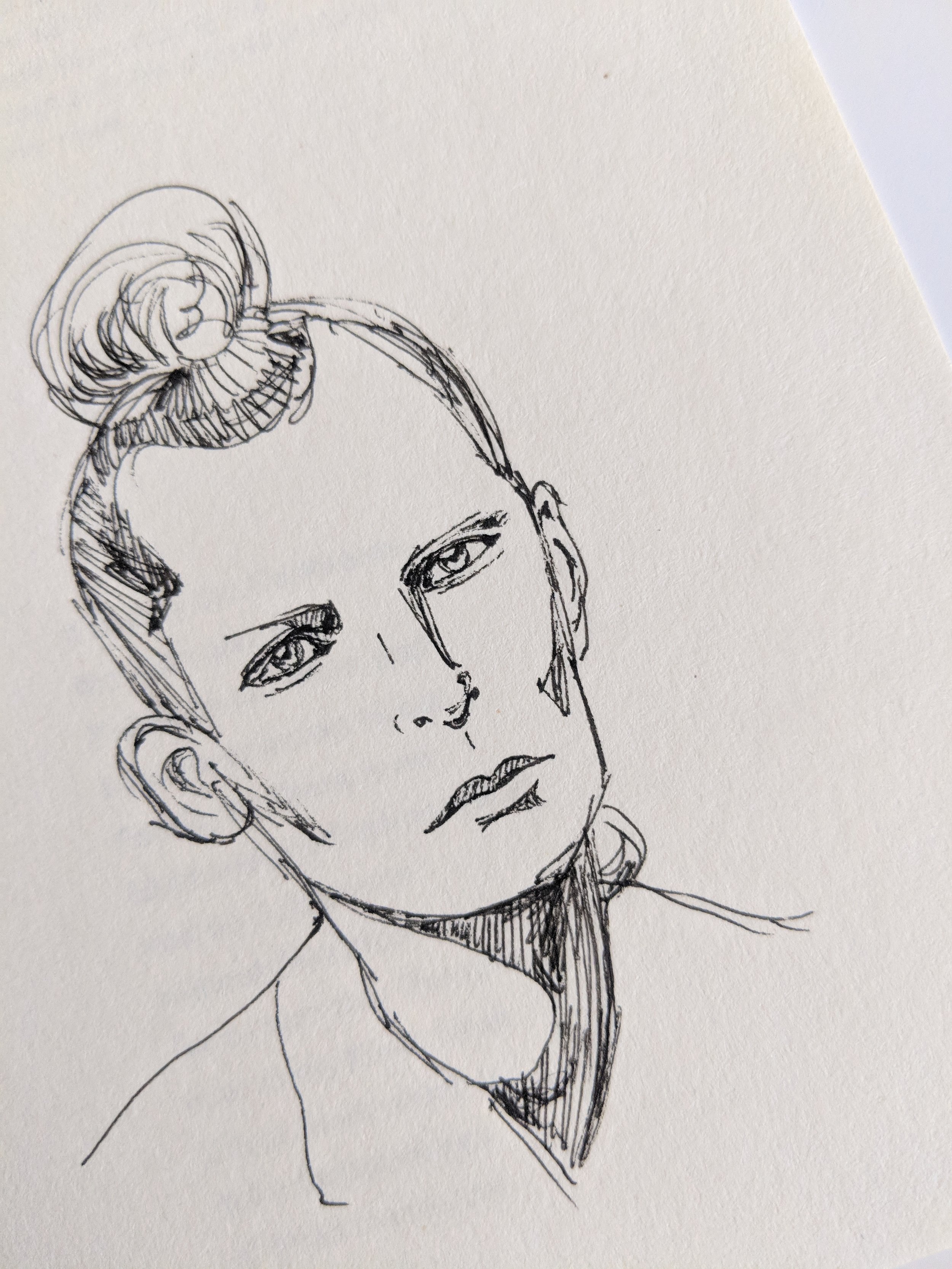 Line drawing of a woman with a serious expression, with her hair styled in a bun.