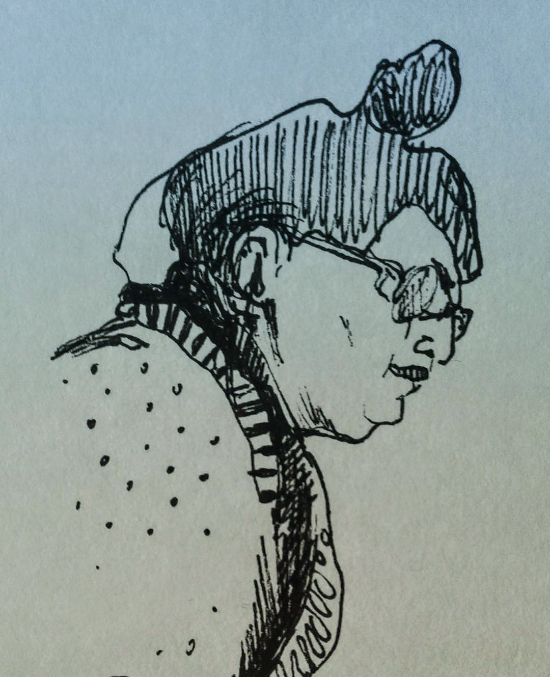 Black and white sketch of a person with glasses and a polka-dot shirt, seen in profile with an attentive expression.