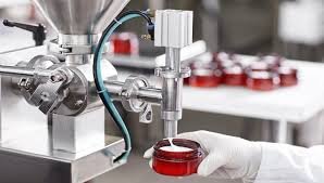 Laboratory technician using equipment to transfer biological sample into a petri dish.