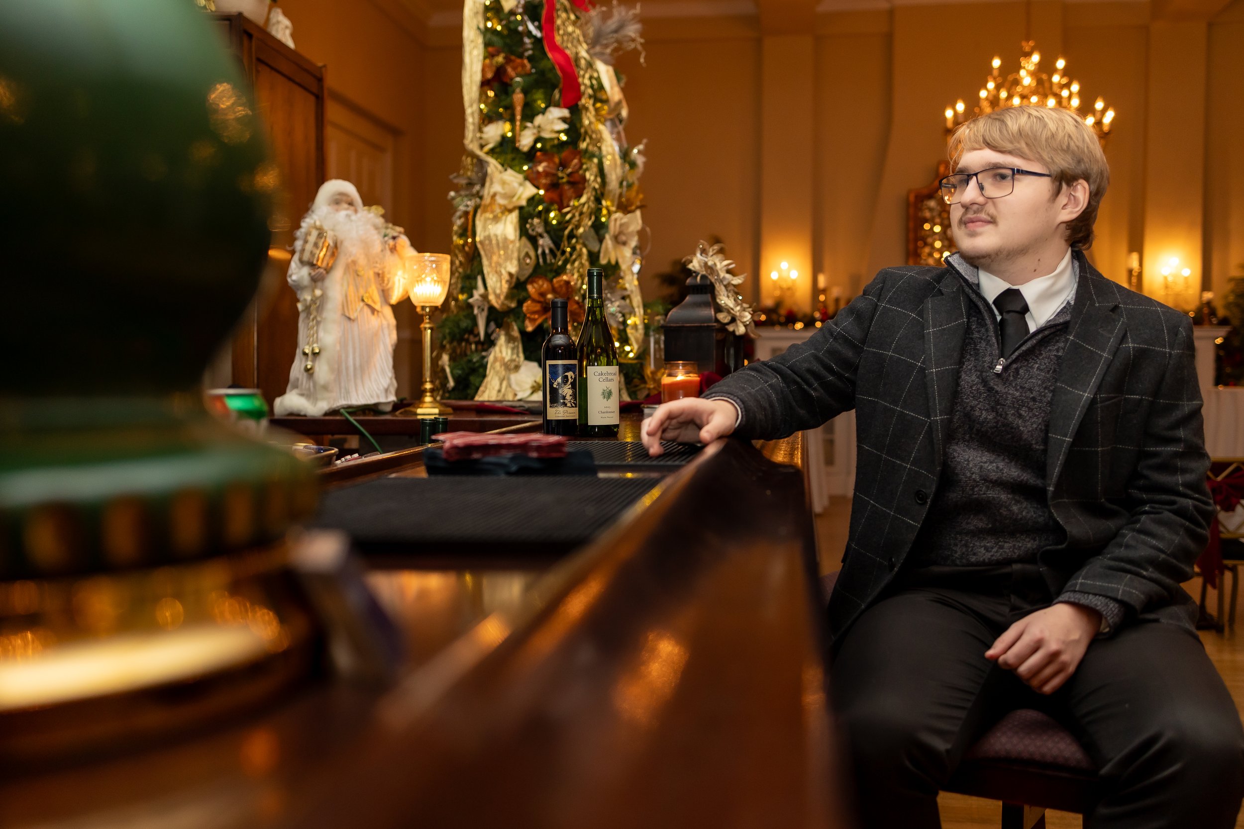 Guest enjoying a private tasting experience with wine and holiday décor in Fredericksburg, VA