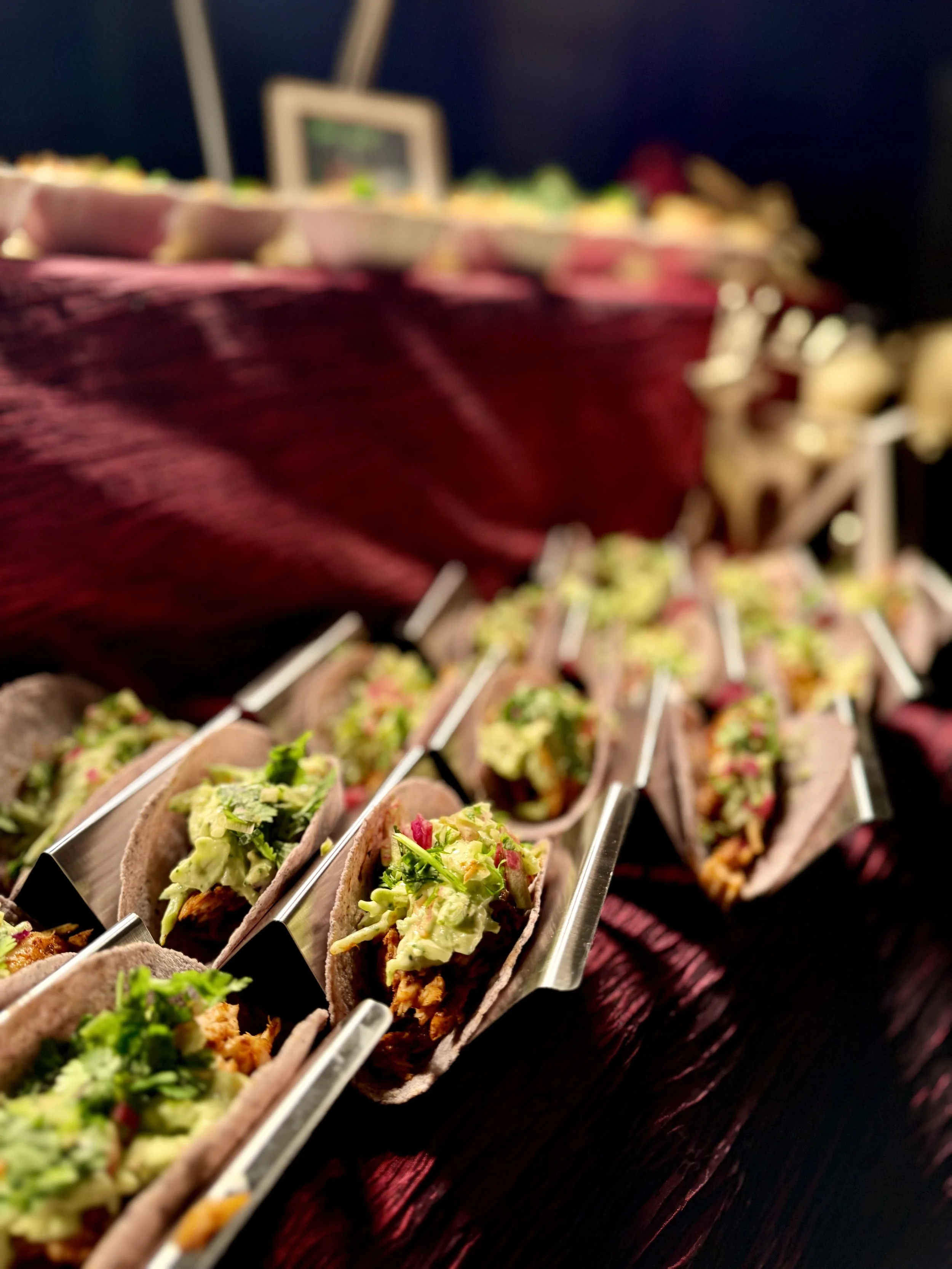 Gourmet taco display with assorted fillings presented in individual holders at a catered event in Fredericksburg, VA