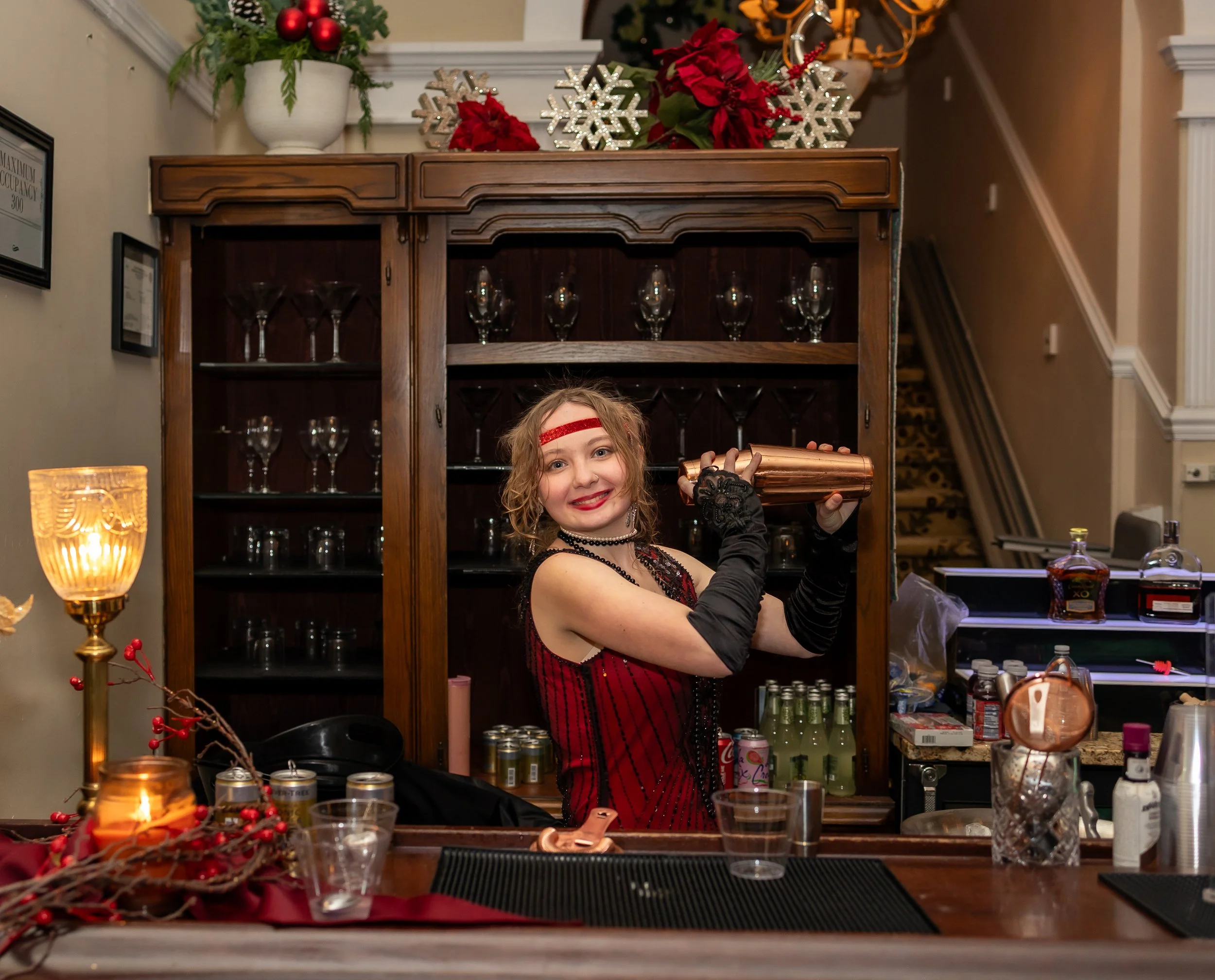 On The Fly Tapsters bartender mixing cocktails at a holiday event bar setup in Fredericksburg VA featuring professional catering and bartending services