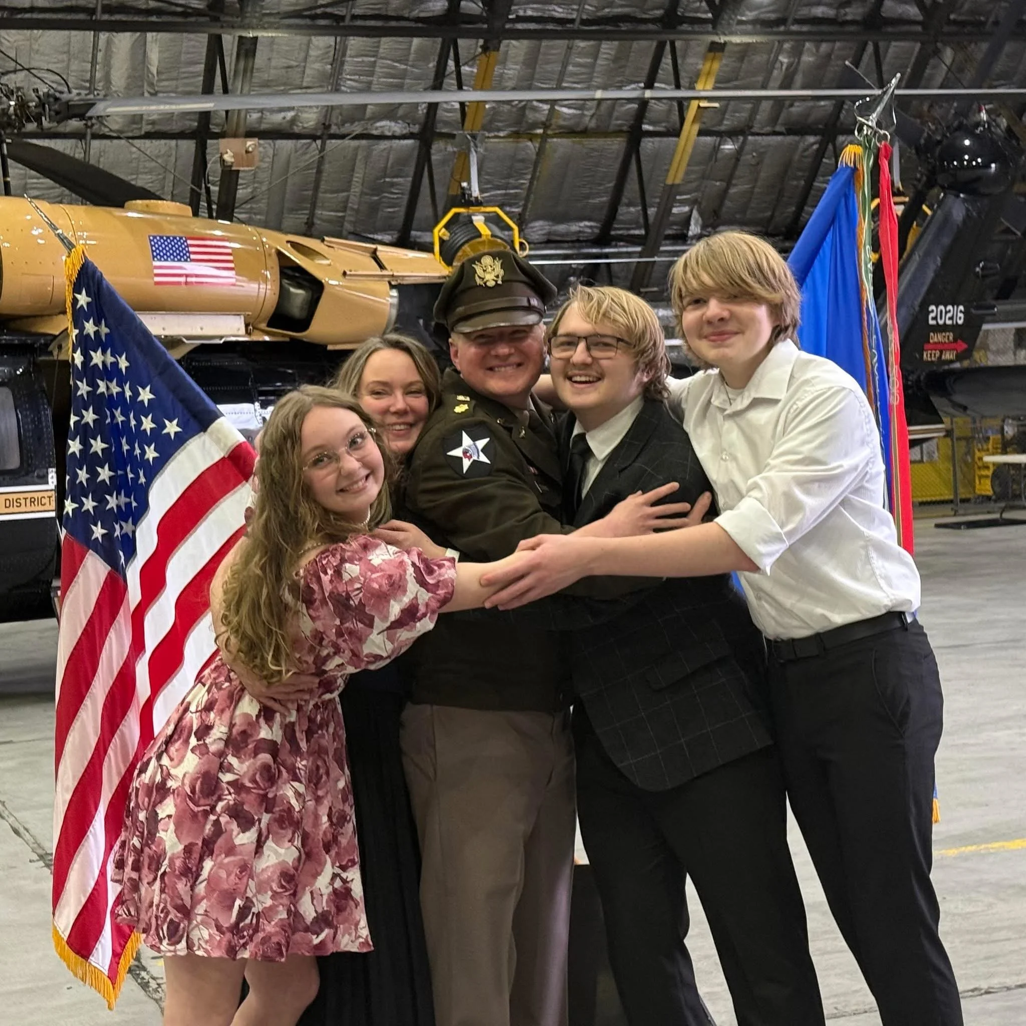 Family-owned business owners in Fredericksburg, VA celebrating together, representing the team behind a local catering and commissary kitchen company