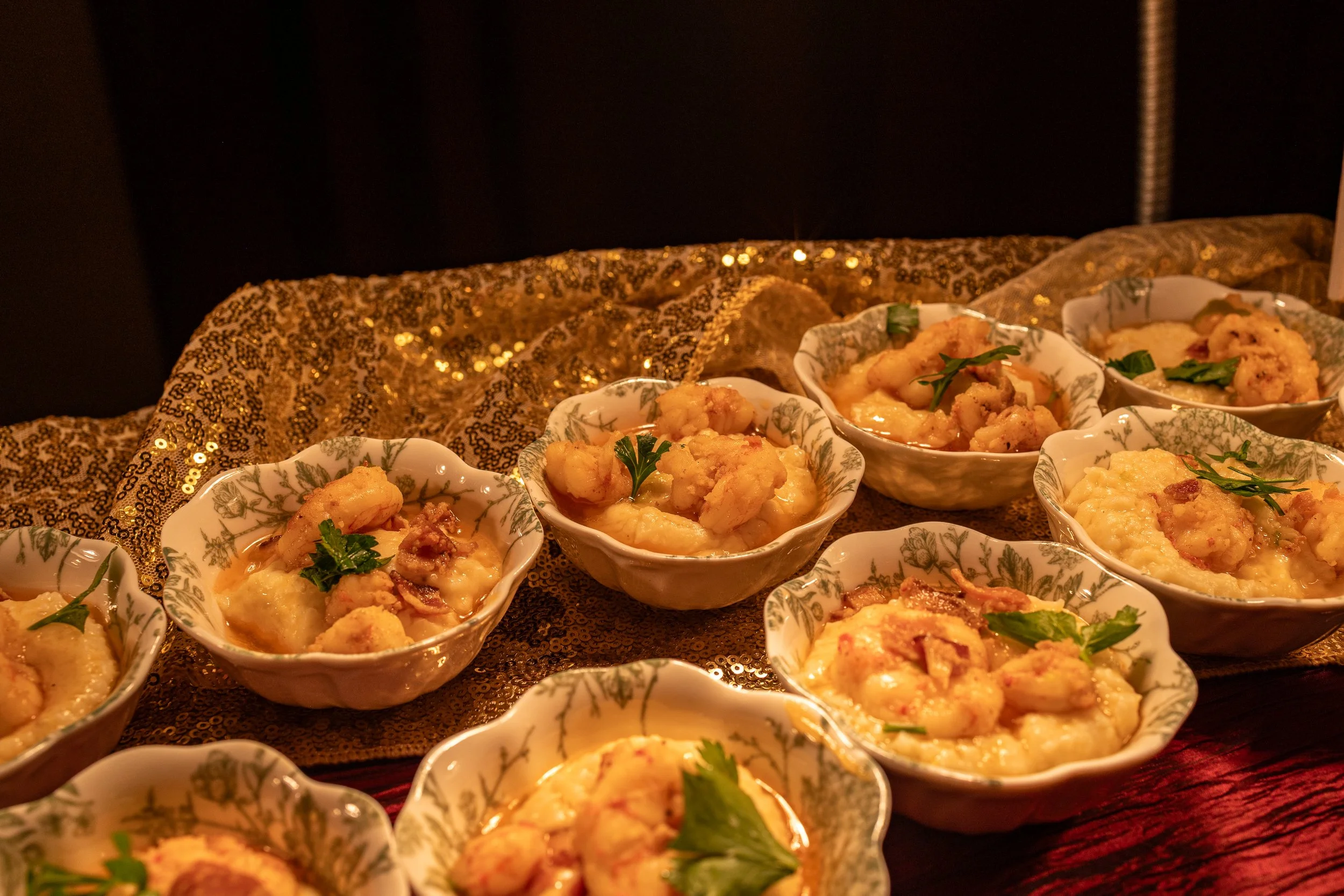 Elegant shrimp and grits appetizer in individual servings, beautifully presented at an On The Fly Culinary event in Fredericksburg, VA