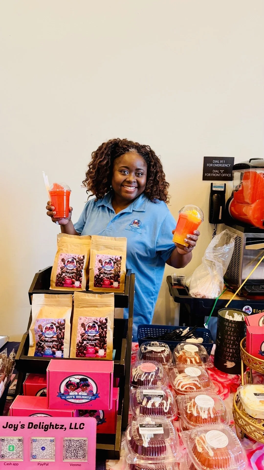 Food vendor at Fredericksburg, VA commissary kitchen displaying packaged baked goods, coffee products, and frozen drinks at a small business booth