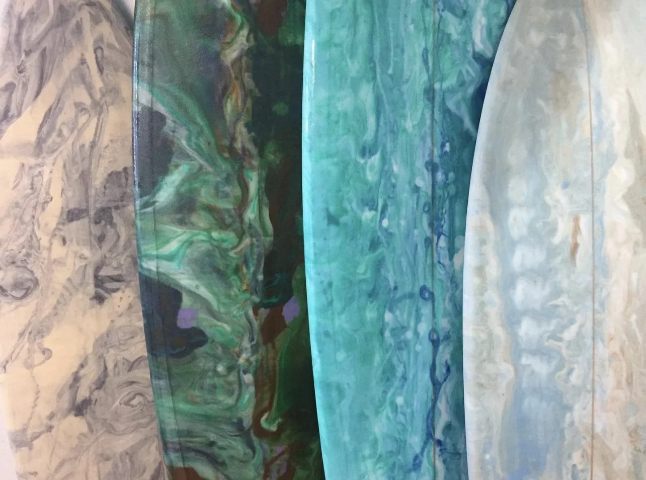 Close-up of a marble surface with swirling pattern in beige, gray, and cream tones.