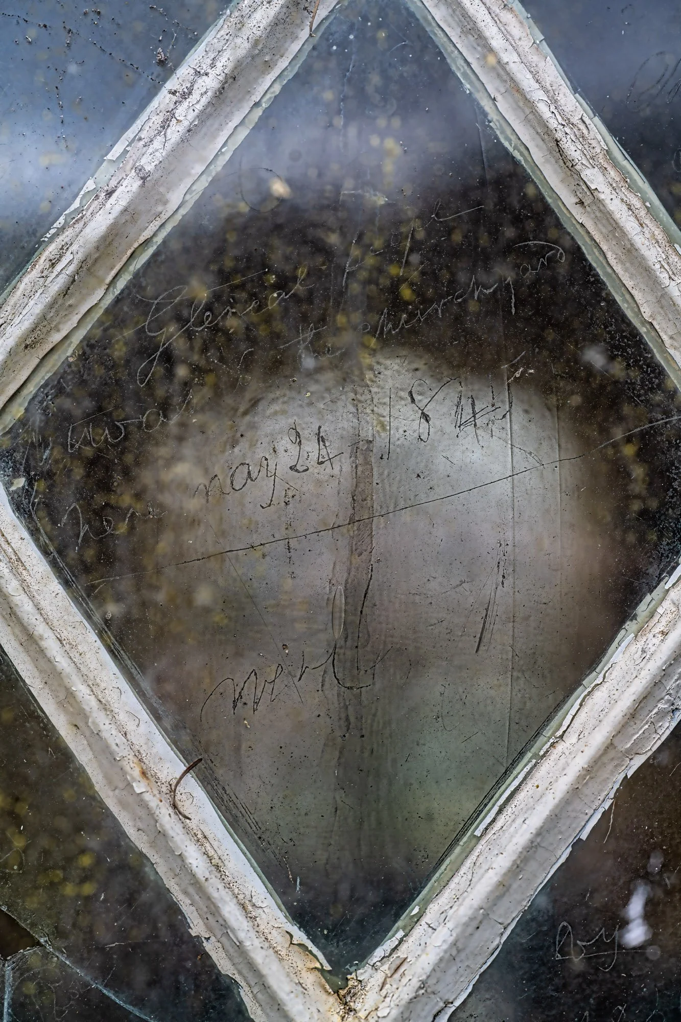 Etching on window of tiCroik Church dating back to the Highland clearances.  The script reads "Glencalvie people was in the churchyard here May 24 1845"