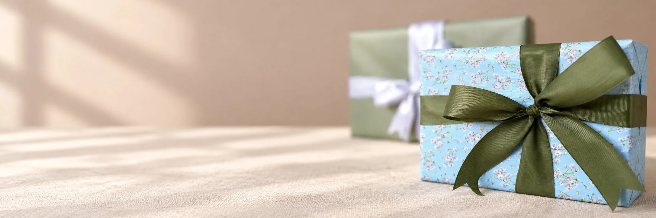 Gift wrapped in botanical paper with an olive satin bow