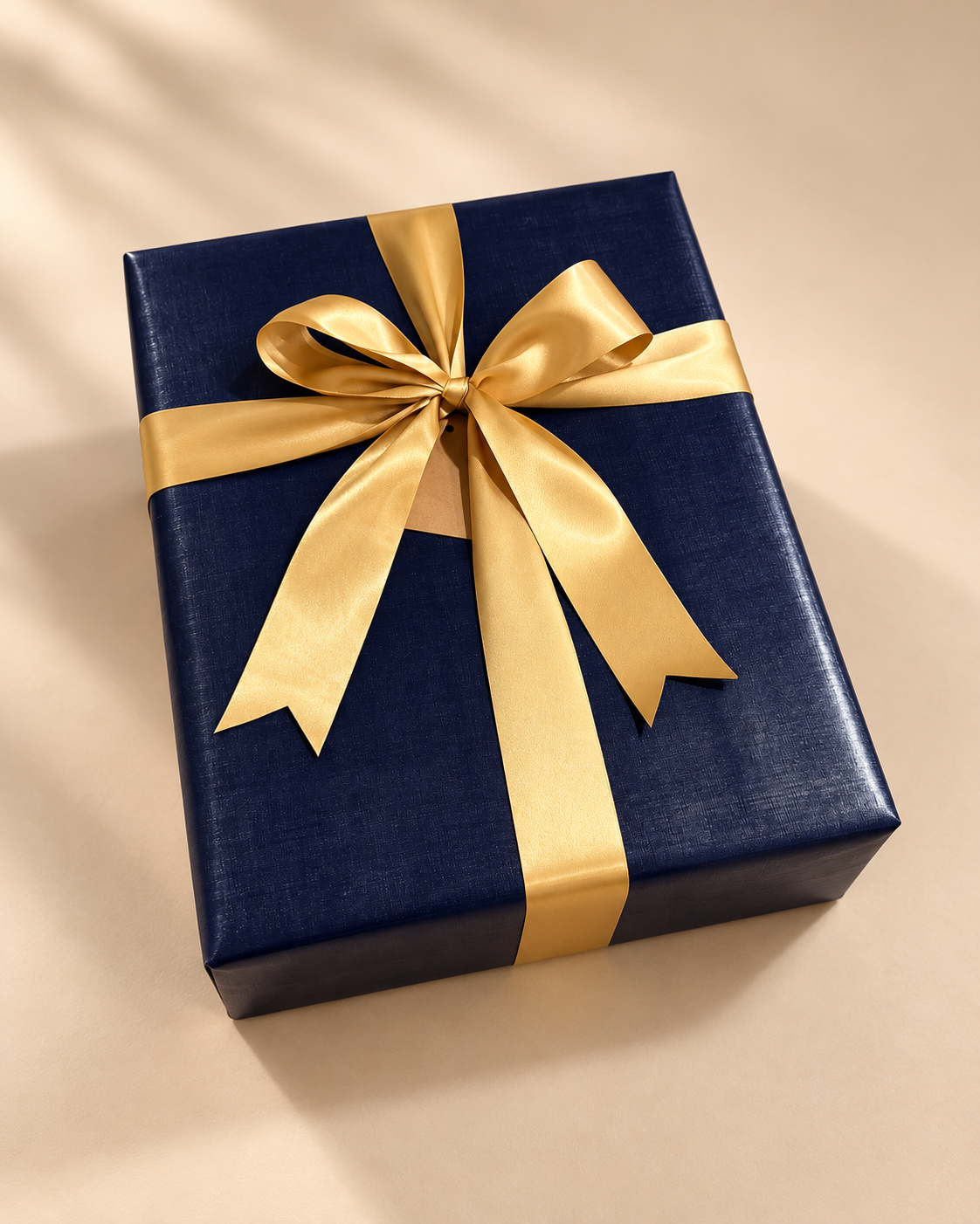 Navy wrapped gift with a gold ribbon bow.
