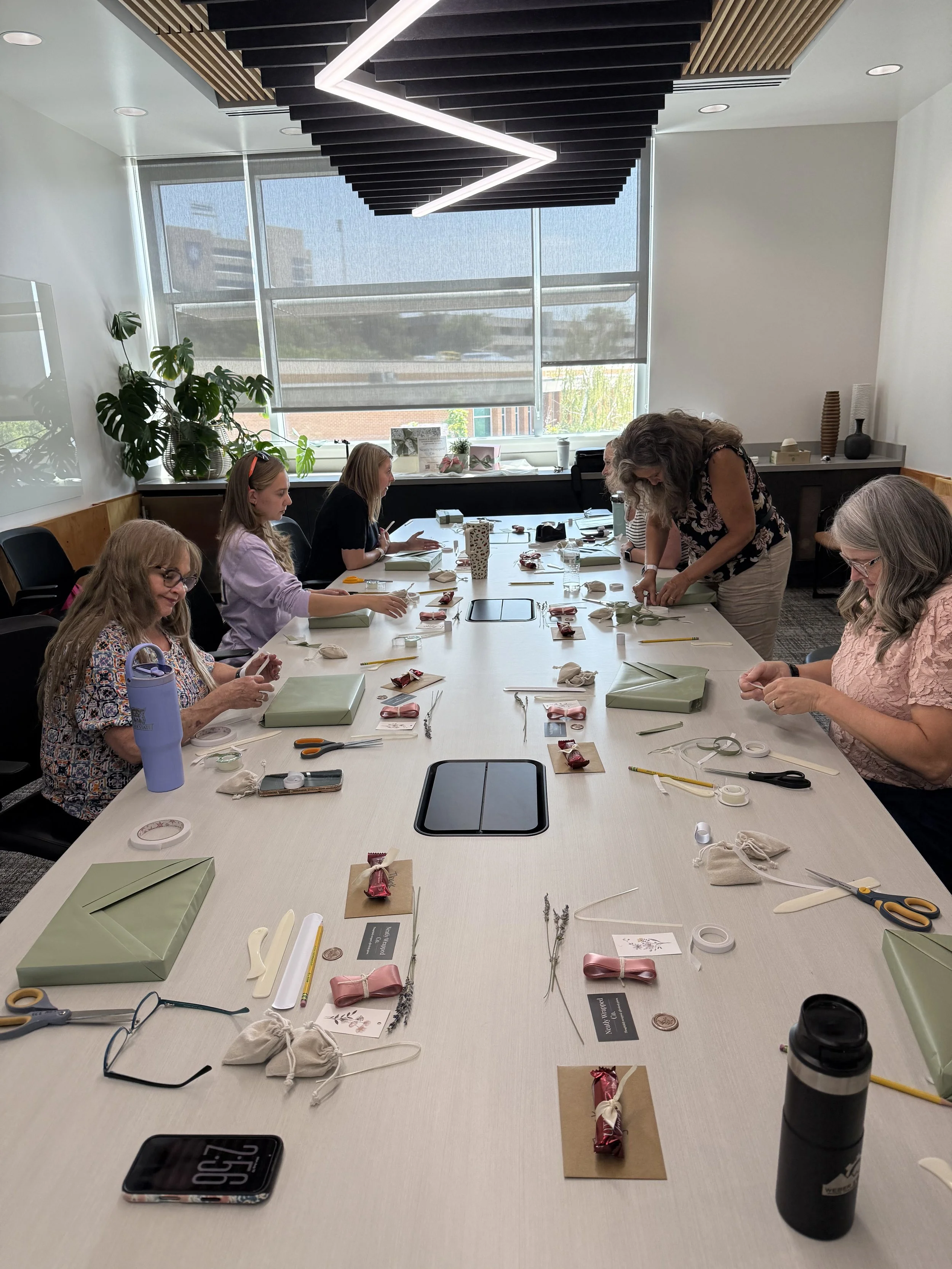 Guests participating in a Neatly Wrapped Co. gift-wrapping workshop at Weber State University.