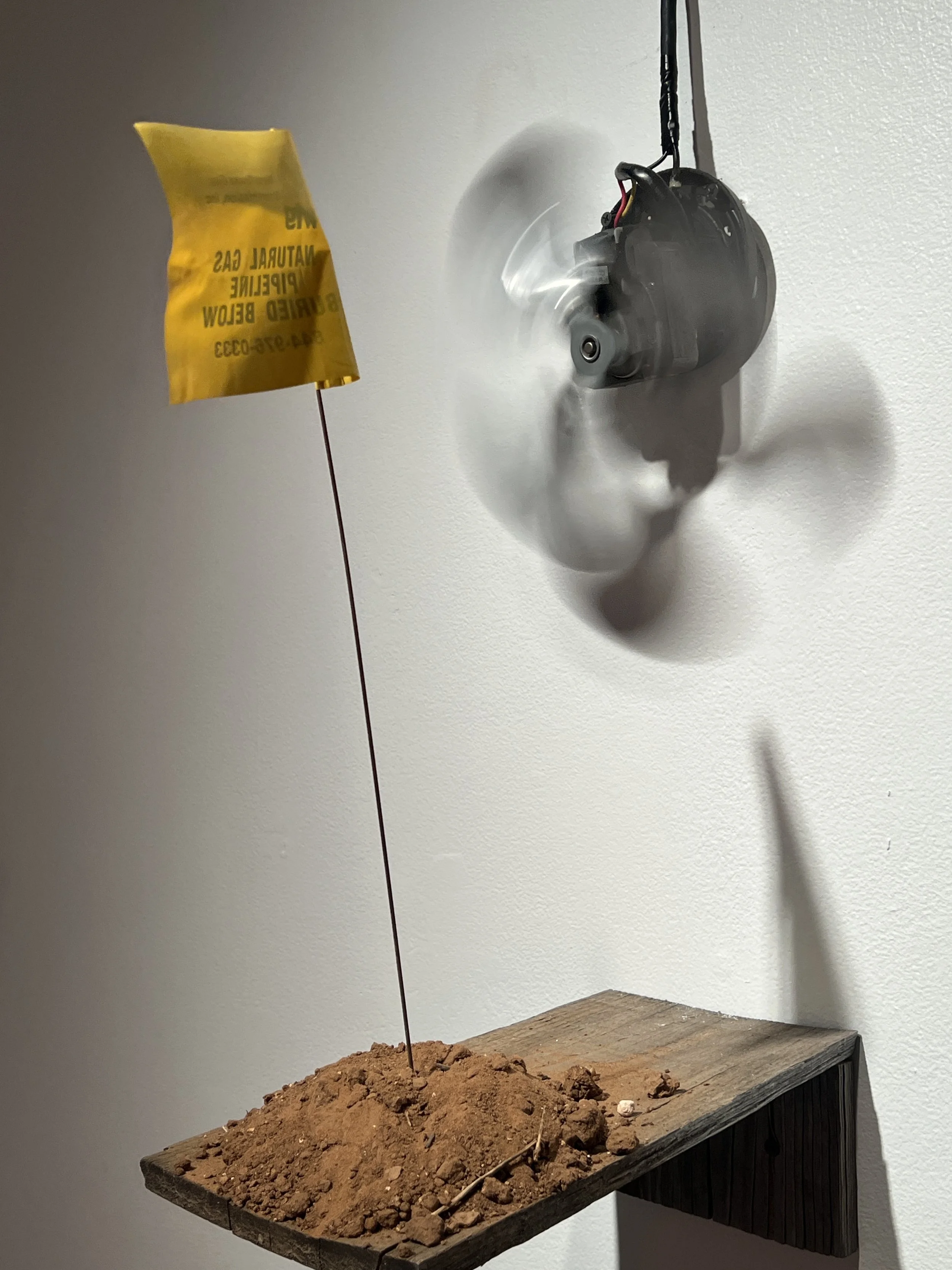 Backroad Lullaby, Fan, flag, dirt, wood, 80x15x13 in, 2025