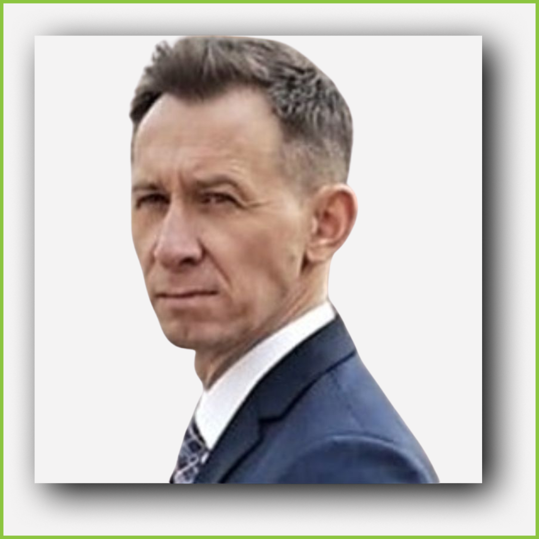 A man in a suit facing sideways with a serious expression.