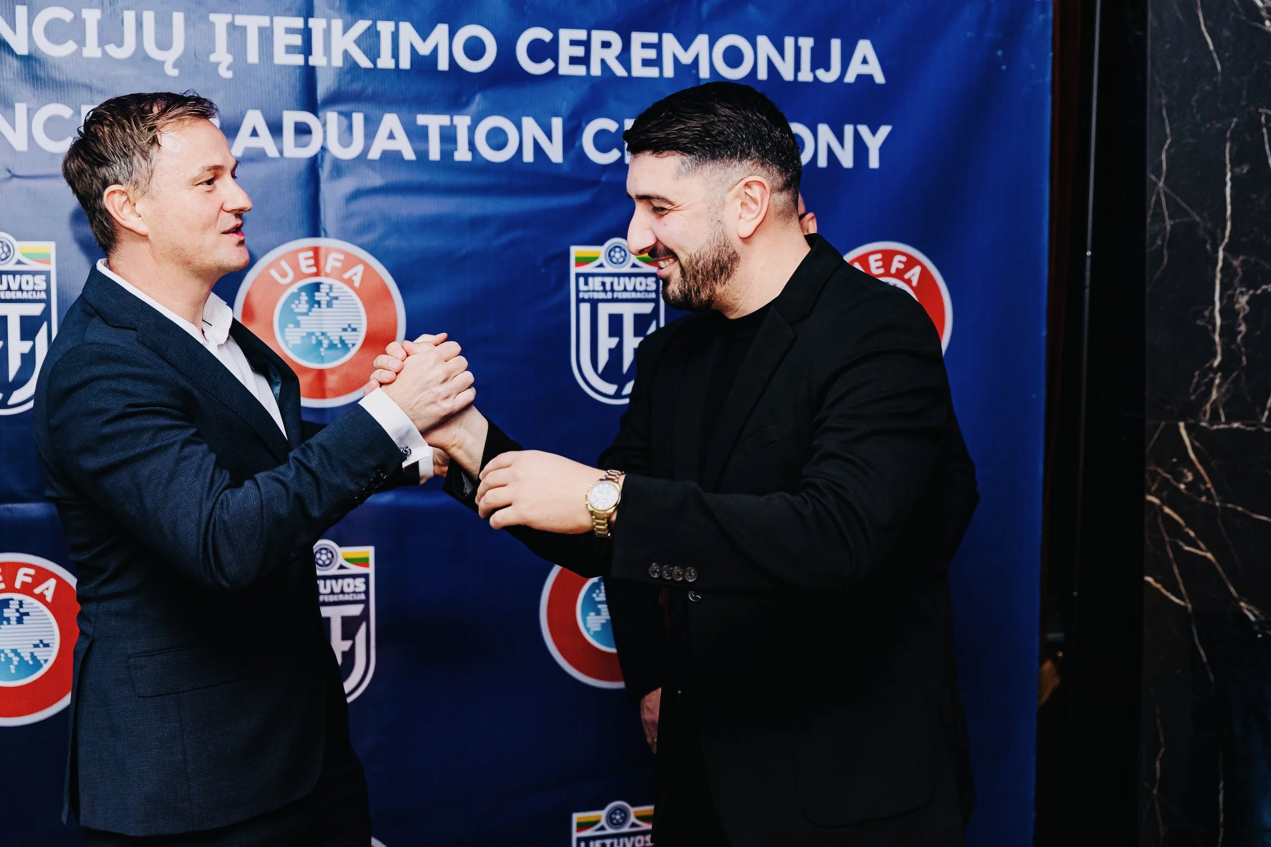 Daniel Wimmer, Head of Coach Education at the Lithuanian Football Federation, congratulating Zurab Amirian on achieving his UEFA Pro Licence Diploma.