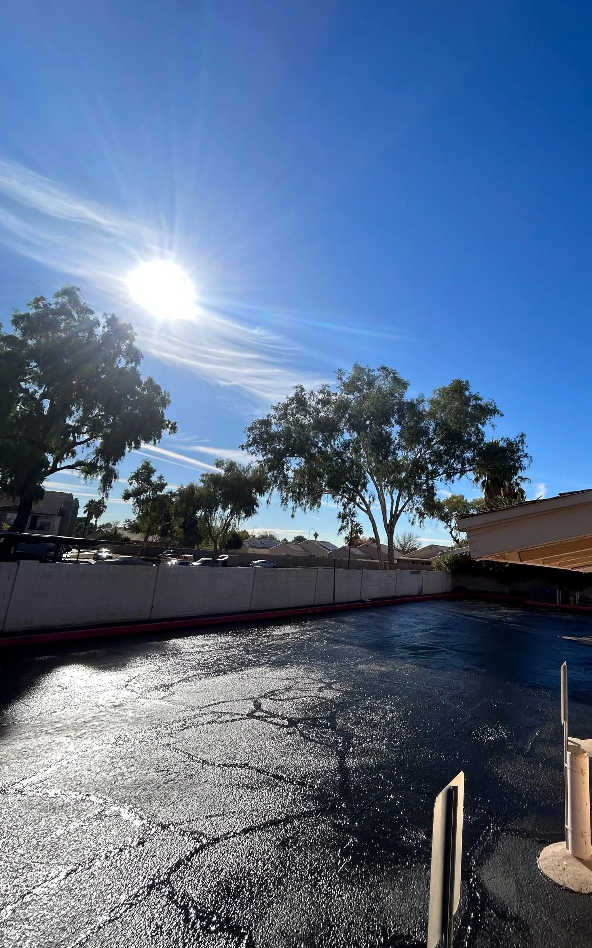 Fresh crackfill and sealcoat under the beaming Arizona sun