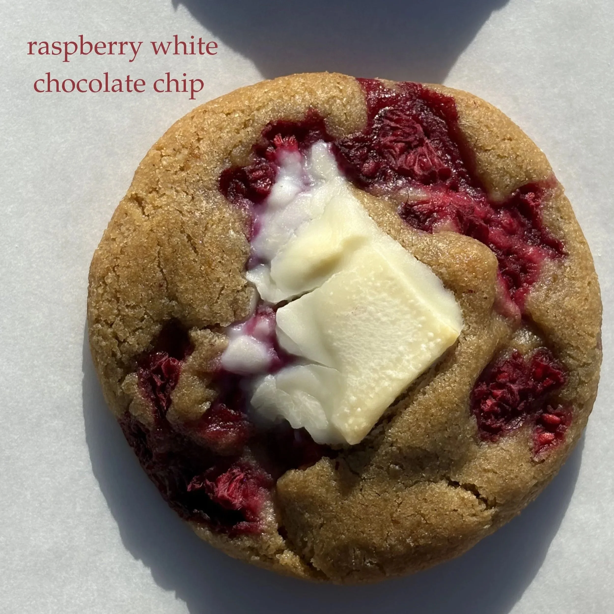 Raspberry white chocolate chip cookie with visible raspberry pieces and white chocolate chunks.