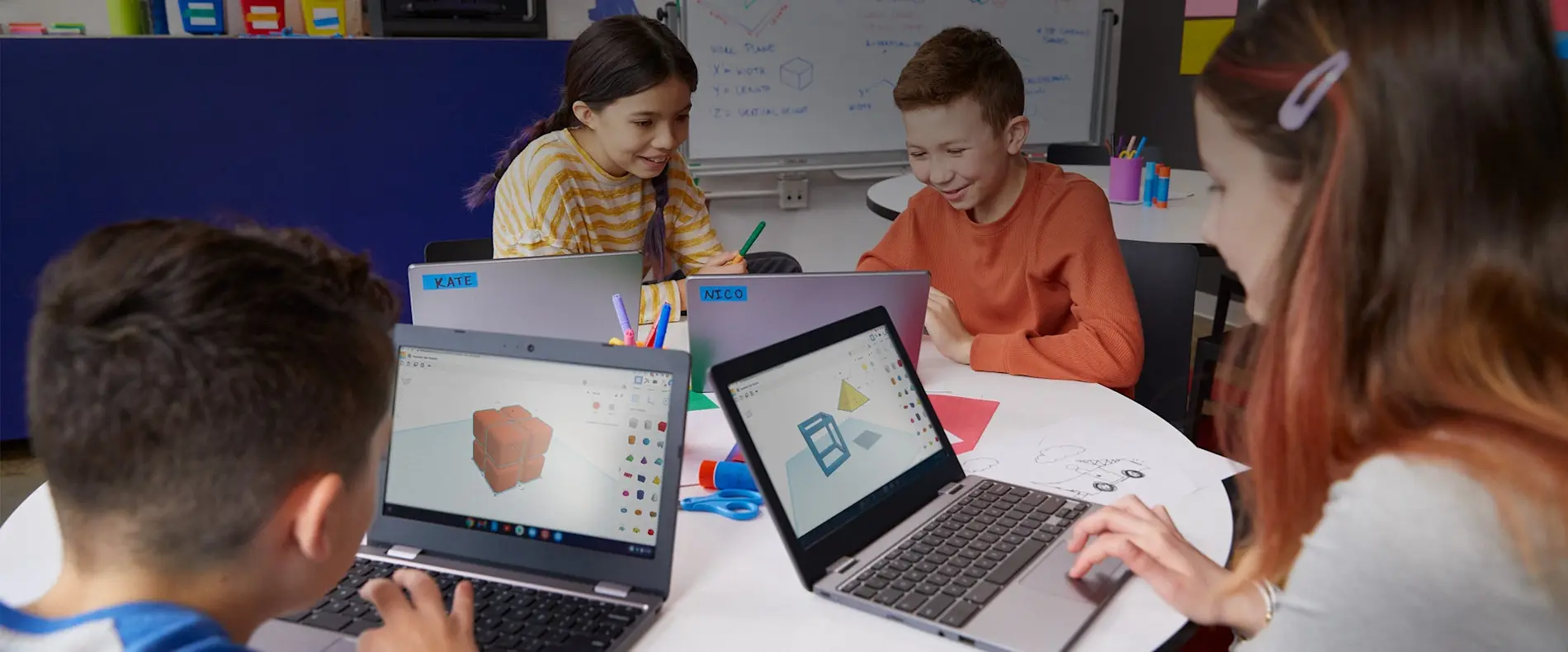 Students working on 3D modeling and design projects at krubots