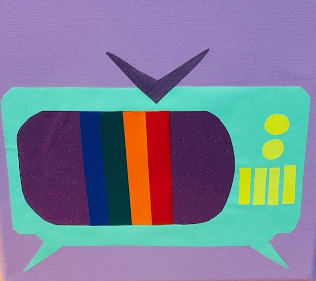 Colorful paper craft of a vintage television with rainbow screen and buttons, placed on a purple background.