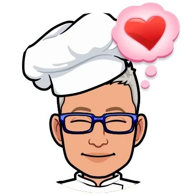 Cartoon chef with a white chef hat, wearing glasses, with a pink thought bubble containing a red heart.