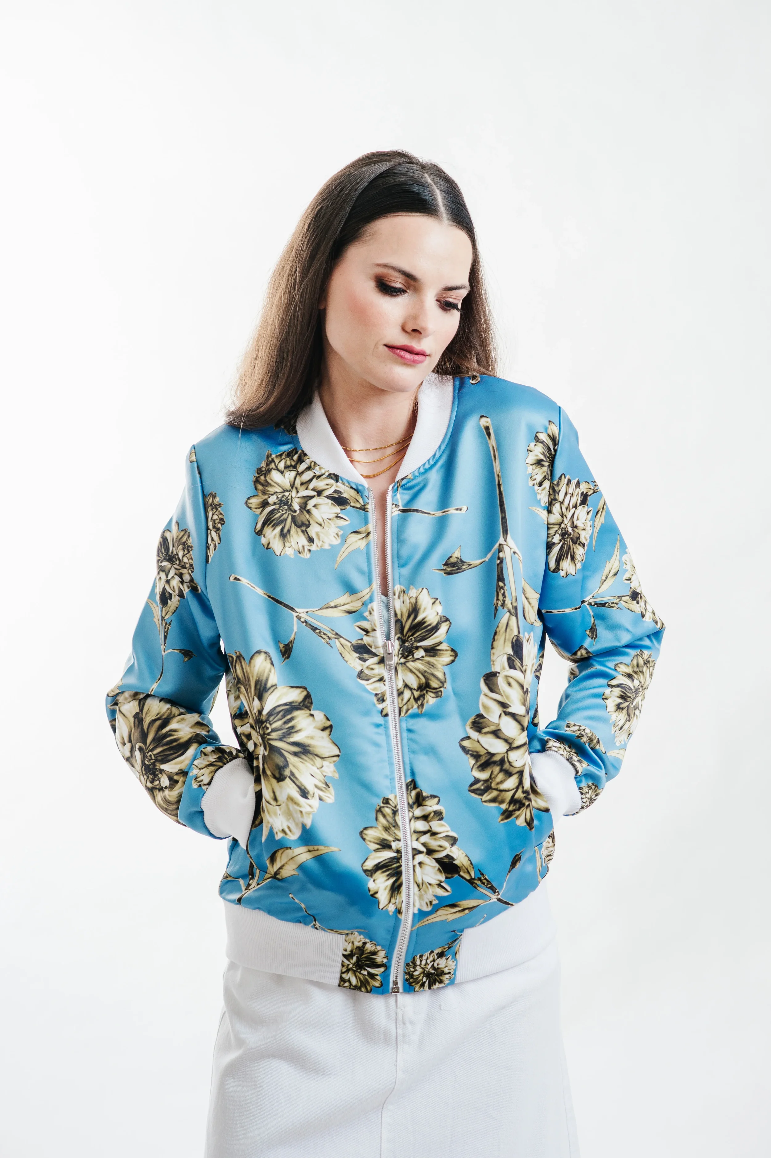 fashion product photography – model wearing blue floral jacket with clean minimal background and modern styling