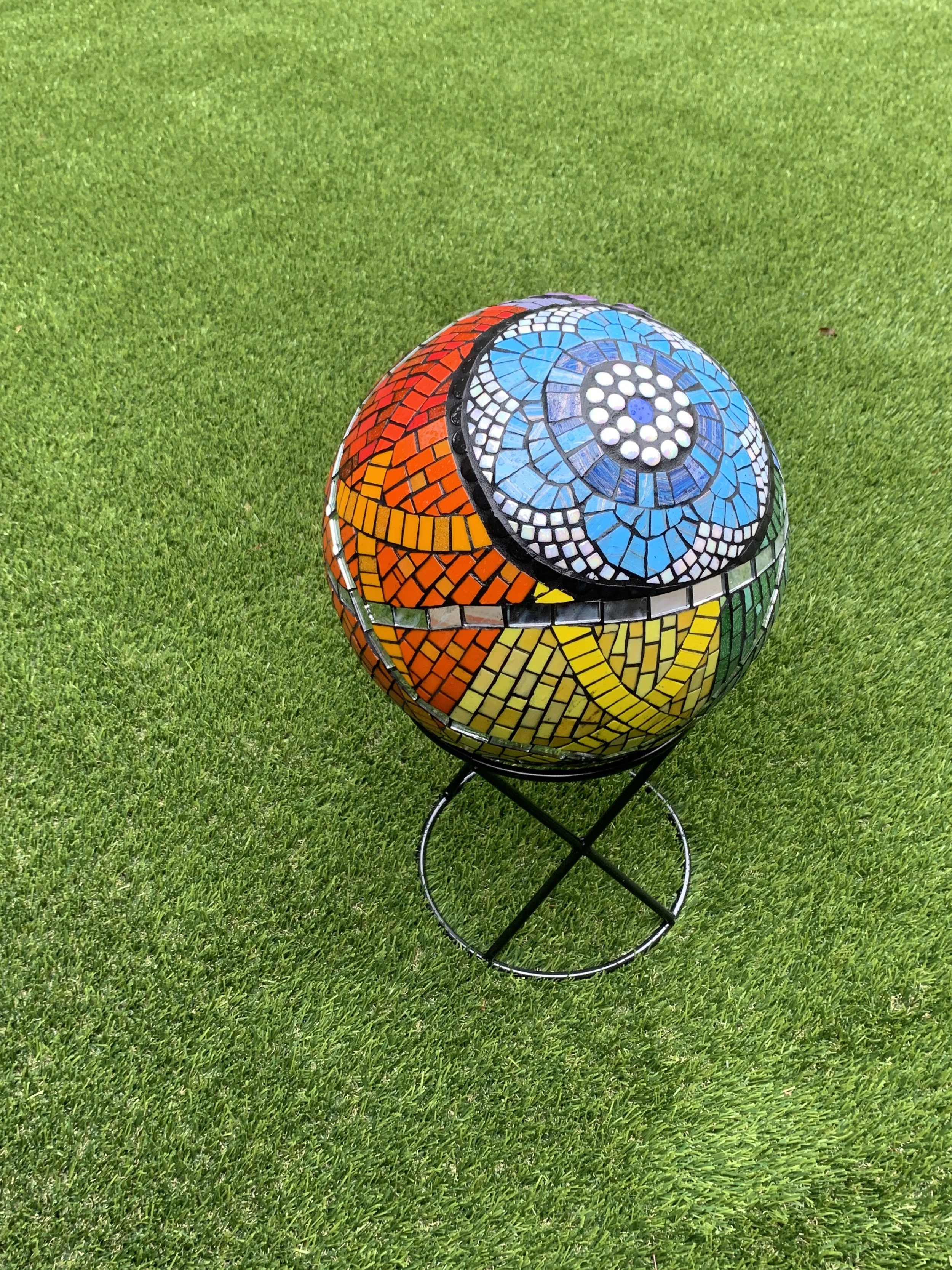 "Universal Intersectional", built on pre-formed 12" styrofoam sphere, covered in mesh and thinset, then tiled in vitreous glass tile and mirror.
