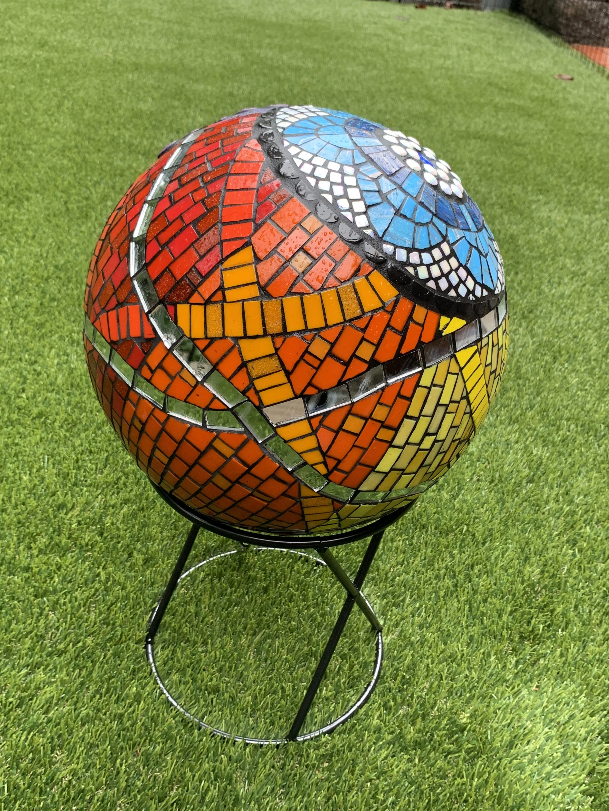 "Universal Intersectional", built on pre-formed 12" styrofoam sphere, covered in mesh and thinset, then tiled in vitreous glass tile and mirror.
