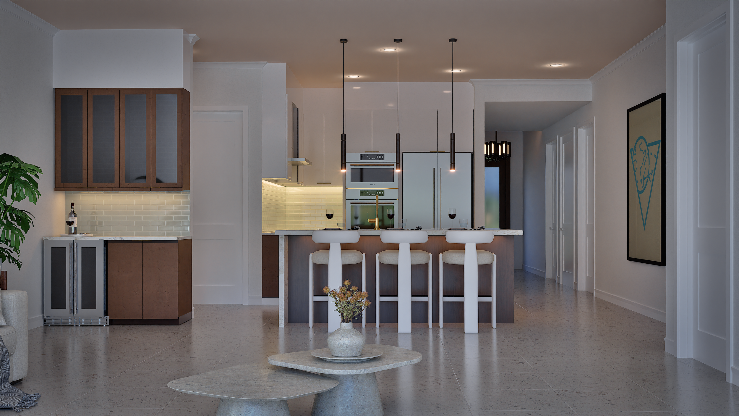 Modern kitchen with white walls, pendant lights over island, beige bar stools, and decorative flower arrangement on small coffee table.