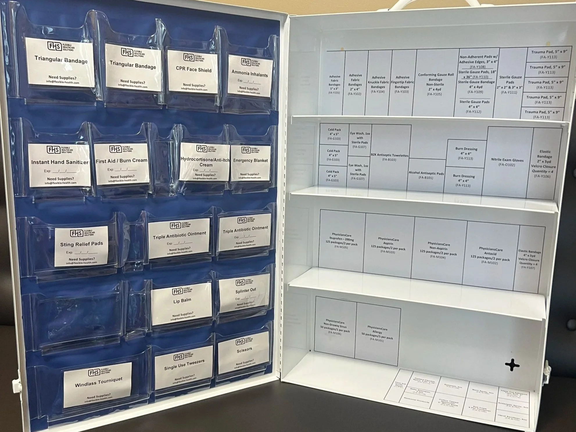 Medical supply cabinet containing various labeled medical items including bandages, gloves, ointments, and other first aid supplies.