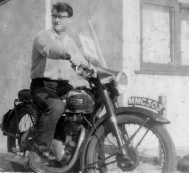 Nick Hobart on his motorcycle in England, circa 1960.