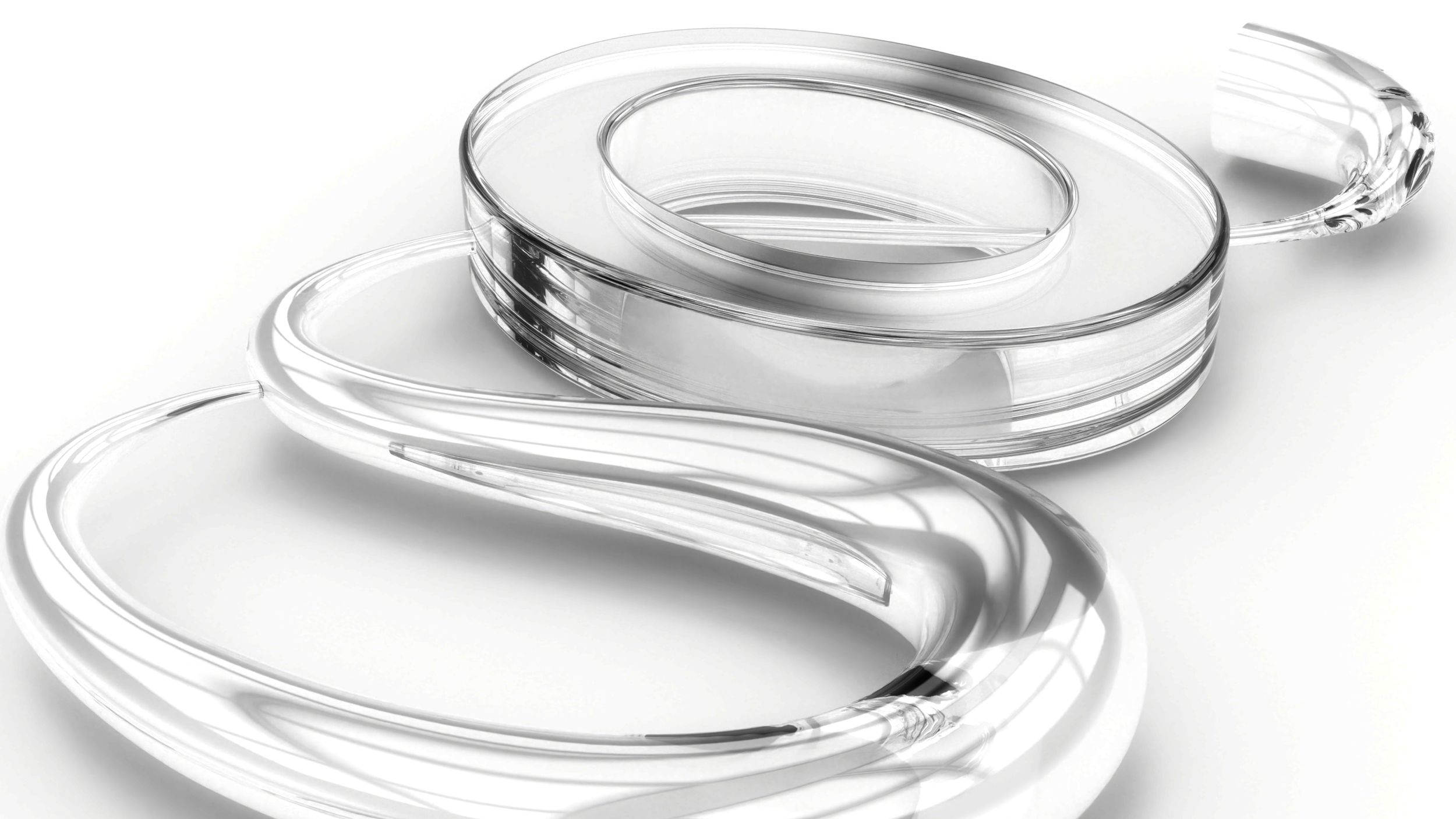 Close-up of clear plastic goggles stacked on a white background.