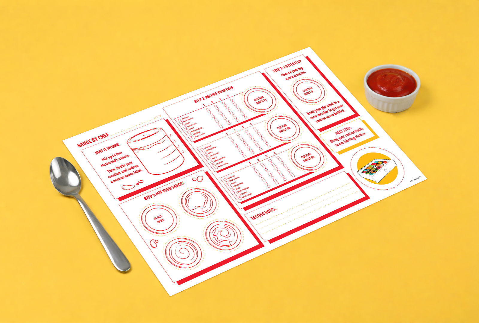A McDonald's sauce customization order sheet on a yellow surface, with a spoon nearby and a cup of ketchup.