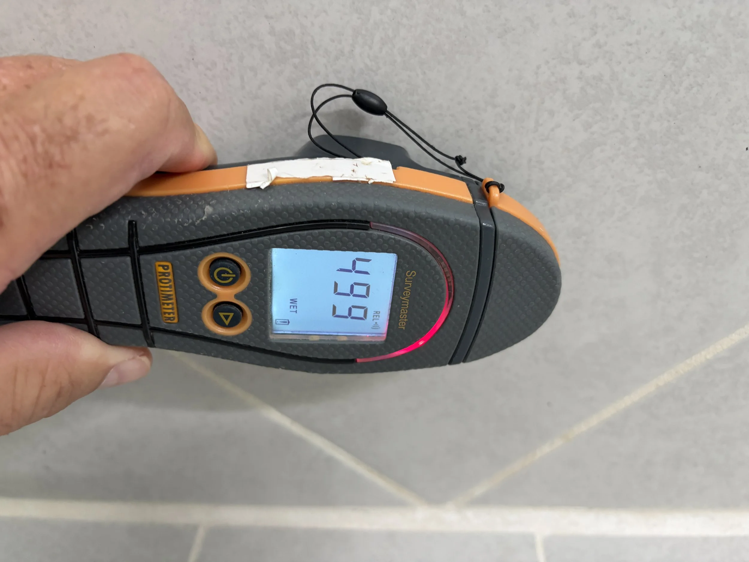 Moisture meter showing water damage during mold inspection in Lake Mary