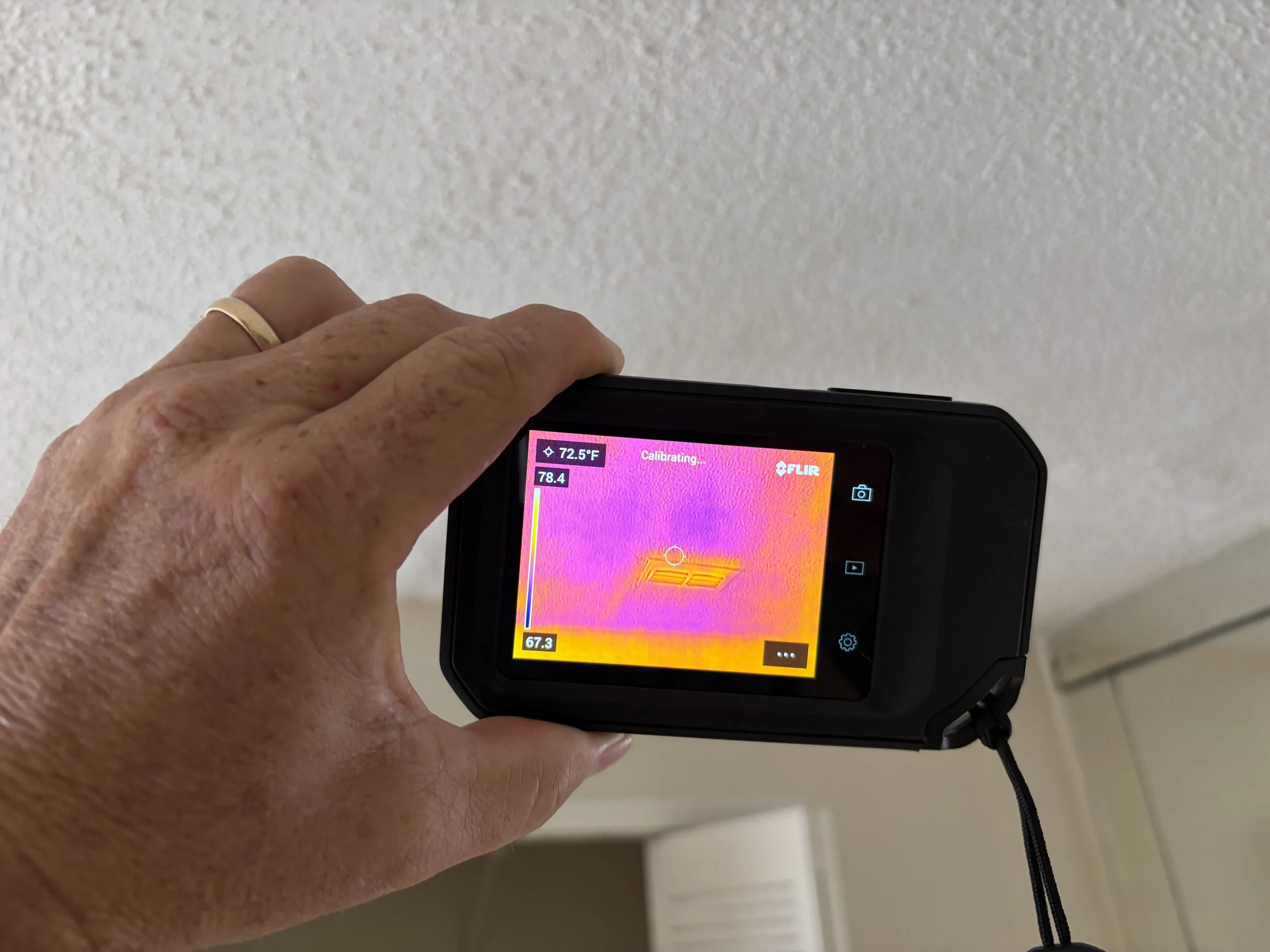 Thermal imaging camera checking for moisture and water damage during a mold inspection.