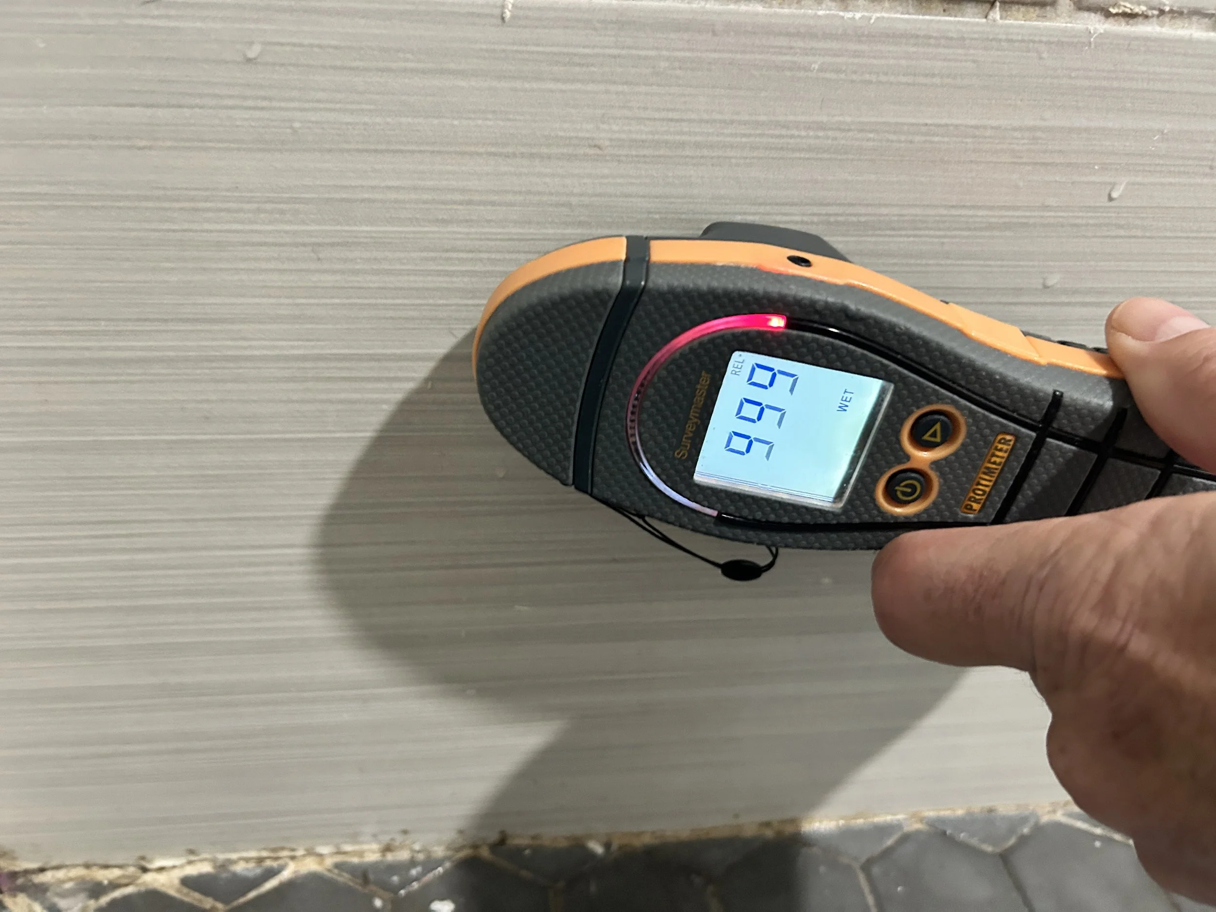 Photo of moisture meter showing elevated moisture during mold inspection in Sanford