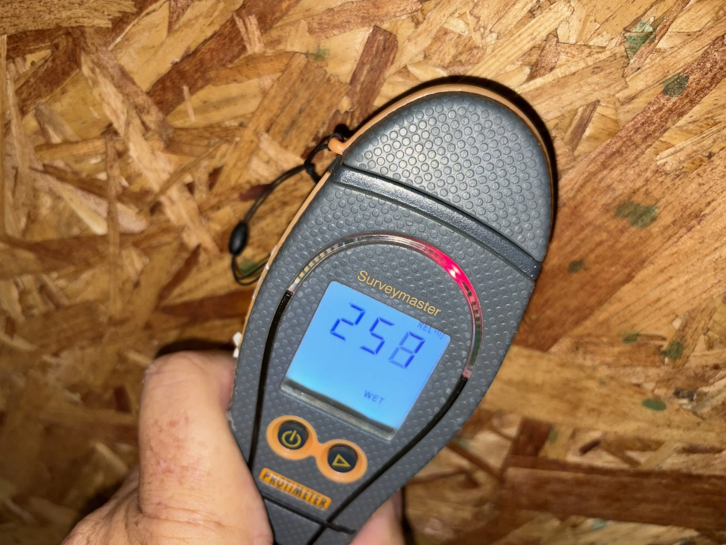 Photo of moisture meter showing elevated moisture on a mold inspection in College Park