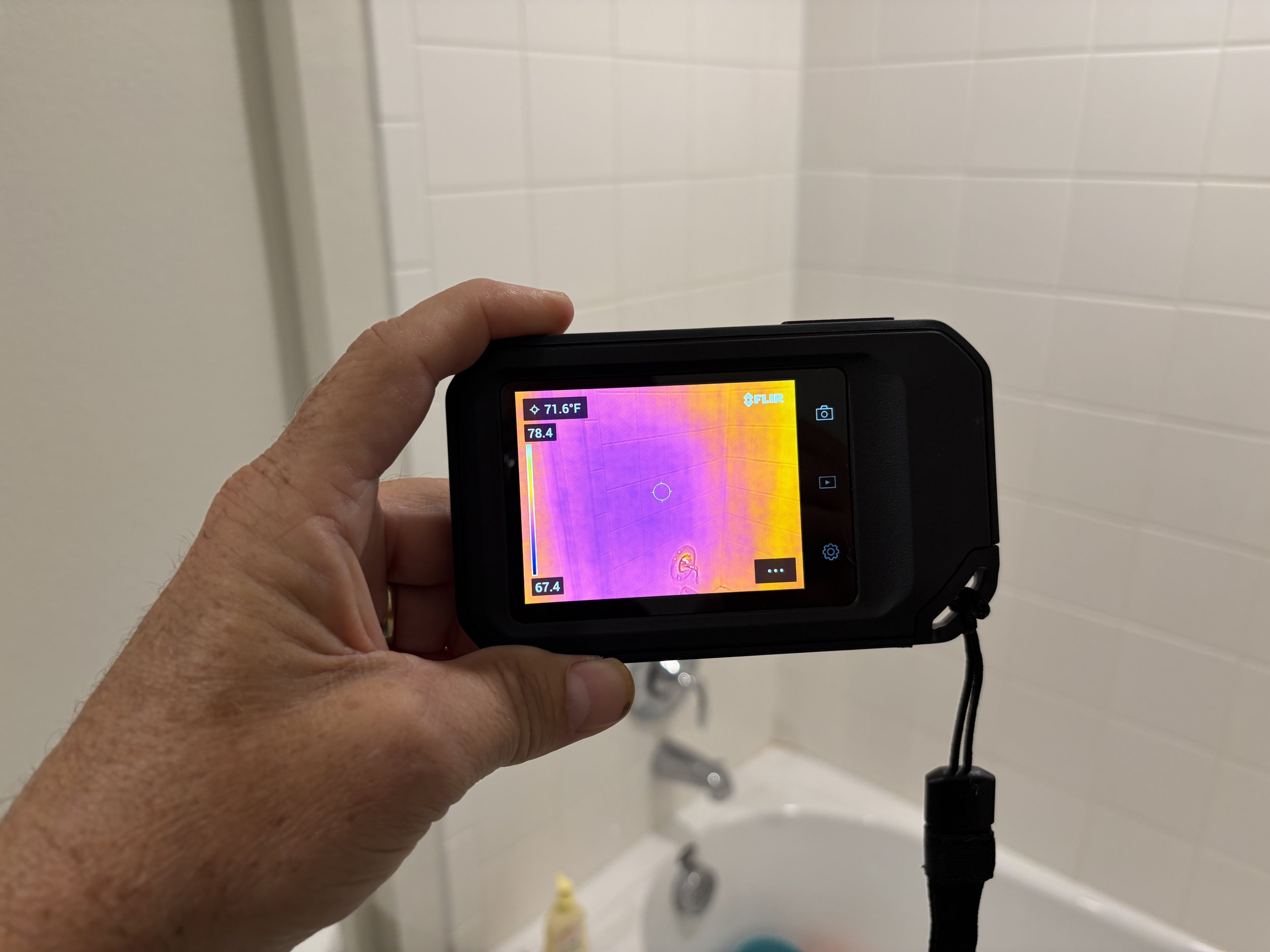Thermal imaging camera checking for moisture and water damage during a mold inspection.