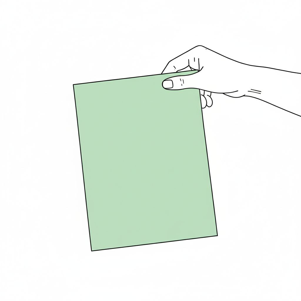 Hånd holder et grønt stykke papir.