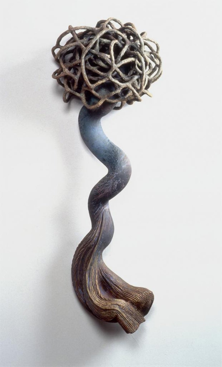 Sculpture resembling a tree with a twisted trunk and a tangled, round canopy made of intertwined branches, against a plain white background.