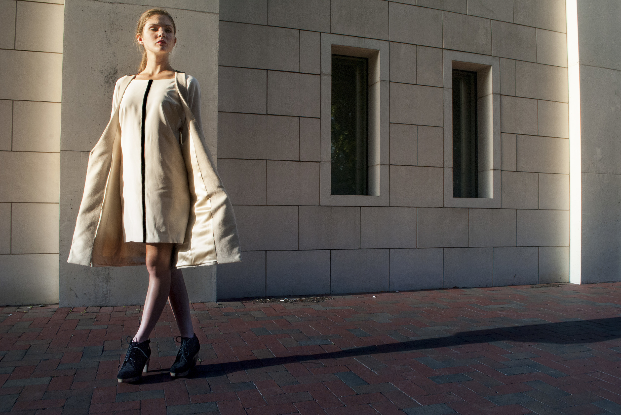 fashion runway walk outdoors geometric building sleek business coat